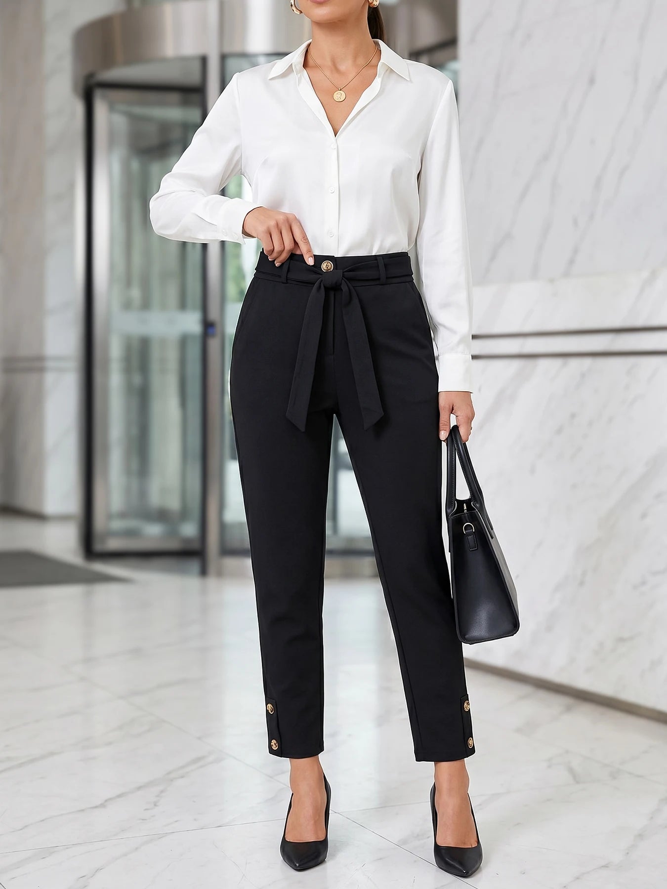 Women's elegant high-waisted formal business trousers with chic button details and cropped length.