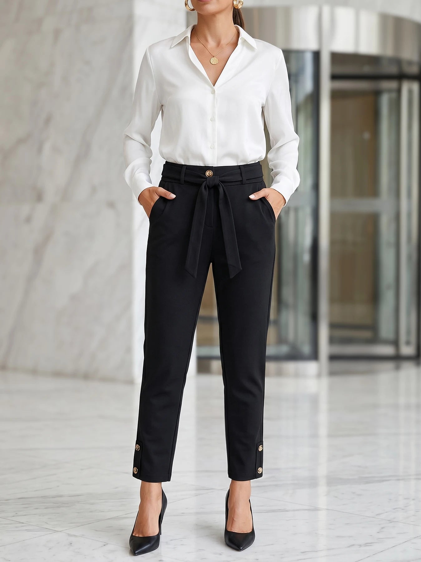 Women's elegant high-waisted formal business trousers with chic button details and cropped length.